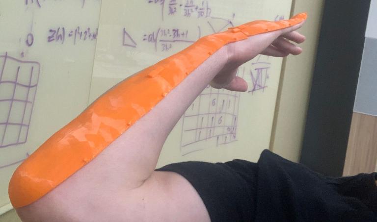 3D-printed template fits over hand and forearm